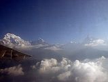 03 Pokhara Flight To Jomsom 01 Annapurna South, Hiunchuli, Gangapurna, Annapurna III, and Machapuchare Gyan and I took the early morning 17-minute flight to Jomsom. You can easily see why these flights can only be run in good weather as we skimmed the tops of several ridges like Ghorepani, with a feeling you could reach out your hand and touch the top of the trees. The mountains came into view, although a little cloudy and hazy. It never stops shocking me how big these mountains are, as they reach for the sky from the low lying hills. Here are Annapurna South, Hiunchuli, Gangapurna, Annapurna III, and Machapuchare.